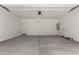 Spacious garage with sealed concrete flooring, white walls, and includes a water heater at 15586 S 181St Dr, Goodyear, AZ 85338