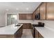 Modern kitchen with stainless steel appliances, quartz countertops, and a center island at 15586 S 181St Dr, Goodyear, AZ 85338