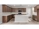 Modern kitchen featuring stainless steel appliances, island with breakfast bar, and quartz countertops at 15586 S 181St Dr, Goodyear, AZ 85338