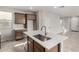 Kitchen features stainless steel appliances, quartz countertops, and a center island with sink at 15586 S 181St Dr, Goodyear, AZ 85338