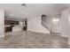 Open-concept living space features tile flooring, staircase and flows into the modern kitchen at 15586 S 181St Dr, Goodyear, AZ 85338