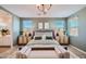 Serene main bedroom featuring soothing color palette, modern furniture and natural light from windows at 16685 W Charlotte Dr, Surprise, AZ 85387