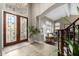 Welcoming foyer with decorative front doors, staircase, and an archway leading to the living room at 1679 E Saltsage Dr, Phoenix, AZ 85048