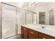 Well-lit bathroom featuring a vanity with a sink, and a shower with sliding glass doors at 16802 N 20Th St, Phoenix, AZ 85022