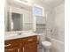 Bathroom features a vanity with wood cabinets and a shower-tub combo with white tiled walls at 16802 N 20Th St, Phoenix, AZ 85022
