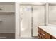 Bathroom featuring a shower with glass door, with vanity with drawers and a view into the closet at 16802 N 20Th St, Phoenix, AZ 85022