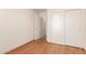 Bedroom featuring light hardwood floors, a closet, and a doorway that leads to another room at 16802 N 20Th St, Phoenix, AZ 85022