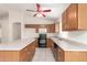 Well-equipped kitchen featuring oak cabinetry, an island, and modern appliances at 16802 N 20Th St, Phoenix, AZ 85022