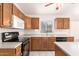 Kitchen featuring oak cabinetry, a microwave, and modern appliances at 16802 N 20Th St, Phoenix, AZ 85022