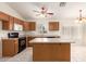 Spacious kitchen with oak cabinets, an island, and modern appliances at 16802 N 20Th St, Phoenix, AZ 85022