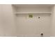 Bare laundry room with access for utilities and shelving for storage at 16802 N 20Th St, Phoenix, AZ 85022