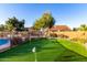 Backyard featuring an artificial putting green and desert landscaping at 17466 N 64Th Ave, Glendale, AZ 85308