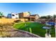 Backyard featuring an artificial putting green and desert landscaping at 17466 N 64Th Ave, Glendale, AZ 85308