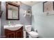 Cozy powder room featuring a pedestal sink and a decorative mirror at 17466 N 64Th Ave, Glendale, AZ 85308