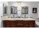 A beautifully designed bathroom with a carved wood double vanity, offering ample space and elegant mirrors at 17466 N 64Th Ave, Glendale, AZ 85308
