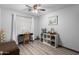 A well-lit bedroom with a desk, a shelving unit and neutral tones offers a versatile space for work or rest at 17466 N 64Th Ave, Glendale, AZ 85308