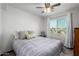 Bright bedroom features a comfortable bed with decorative pillows and a large window, creating a serene atmosphere at 17466 N 64Th Ave, Glendale, AZ 85308