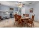 Spacious dining area featuring tile flooring, wooden table and chairs, and a view of the stairway at 17466 N 64Th Ave, Glendale, AZ 85308