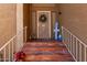 Inviting front entrance with brick steps, decorative plants, and wrought iron details at 17466 N 64Th Ave, Glendale, AZ 85308