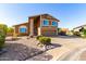 Two-story home boasts a desert landscape, spacious driveway, and inviting curb appeal at 17466 N 64Th Ave, Glendale, AZ 85308