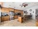 Spacious kitchen featuring granite countertops, stainless steel appliances, and a center island with seating at 17466 N 64Th Ave, Glendale, AZ 85308