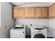 Bright laundry room featuring a washer and dryer, sink, and cabinets at 17466 N 64Th Ave, Glendale, AZ 85308