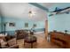 Comfortable living room featuring a mounted marlin and rich hardwood floors at 17466 N 64Th Ave, Glendale, AZ 85308