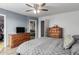 A serene main bedroom features a ceiling fan, walk-in closet, and access to an ensuite bathroom with a soaking tub at 17466 N 64Th Ave, Glendale, AZ 85308