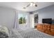 A bright main bedroom with a window and a large dresser, offering ample storage and natural light at 17466 N 64Th Ave, Glendale, AZ 85308