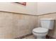 A convenient powder room features neutral tile, seamlessly blending style and functionality in a compact space at 17466 N 64Th Ave, Glendale, AZ 85308