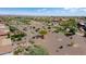 Backyard view of a lovely desert home with a fire pit area, and desert golf course in the background at 20453 N 264Th Ave, Buckeye, AZ 85396
