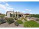 This landscaped backyard features a fire pit, a covered patio, and beautiful desert plants at 20453 N 264Th Ave, Buckeye, AZ 85396