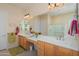 Bathroom featuring dual sinks, a vanity, a large mirror, and a glass door shower at 20453 N 264Th Ave, Buckeye, AZ 85396
