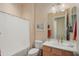 Well-lit bathroom with a sink vanity, and shower with curtain at 20453 N 264Th Ave, Buckeye, AZ 85396
