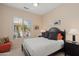 Comfortable bedroom with a black bed frame, a window with blinds, and a ceiling fan at 20453 N 264Th Ave, Buckeye, AZ 85396