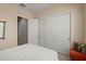 Bright bedroom with direct bathroom access and sliding closet doors at 20453 N 264Th Ave, Buckeye, AZ 85396