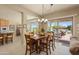 Bright dining area with ample seating and an inviting view of the backyard patio at 20453 N 264Th Ave, Buckeye, AZ 85396