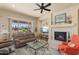 Cozy living room with a fireplace and a view of the beautiful desert landscape at 20453 N 264Th Ave, Buckeye, AZ 85396