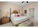 Comfortable main bedroom featuring a wooden bed frame, nightstand, and ensuite bathroom at 20453 N 264Th Ave, Buckeye, AZ 85396