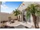 Outdoor patio space with a chair and mature palm trees, surrounded by a wall at 20453 N 264Th Ave, Buckeye, AZ 85396