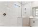 Luxurious bathroom showcasing marble tiled shower, frameless glass enclosure, and updated fixtures at 21232 N 58Th St, Phoenix, AZ 85054