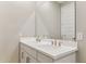Bathroom featuring a double sink vanity with modern fixtures and a large mirror at 21232 N 58Th St, Phoenix, AZ 85054