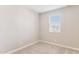Bright bedroom featuring neutral carpet and paint, with a window providing natural light at 21232 N 58Th St, Phoenix, AZ 85054