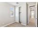 Bedroom with window, plush carpeting, and closet, offers comfort and convenience, enhanced by neutral walls at 21232 N 58Th St, Phoenix, AZ 85054