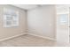 Bright bedroom with a window and soft carpeting, featuring neutral walls for relaxation and comfort at 21232 N 58Th St, Phoenix, AZ 85054