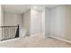 Upstairs hallway with neutral walls, soft carpeting, and railing overlooking the lower level at 21232 N 58Th St, Phoenix, AZ 85054