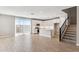 Modern kitchen with white cabinets, an island with a sink, stainless steel appliances, and an open layout that flows into the living area at 21232 N 58Th St, Phoenix, AZ 85054