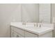 Bathroom with double sink vanity, featuring white countertops, shaker cabinets, and brushed nickel hardware at 21248 N 58Th St, Phoenix, AZ 85054