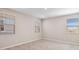 Bright bedroom featuring neutral walls, carpet flooring, and natural light from three windows at 21248 N 58Th St, Phoenix, AZ 85054