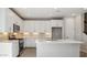 Bright, modern kitchen with white cabinets, stainless steel appliances, and a quartz island at 21248 N 58Th St, Phoenix, AZ 85054